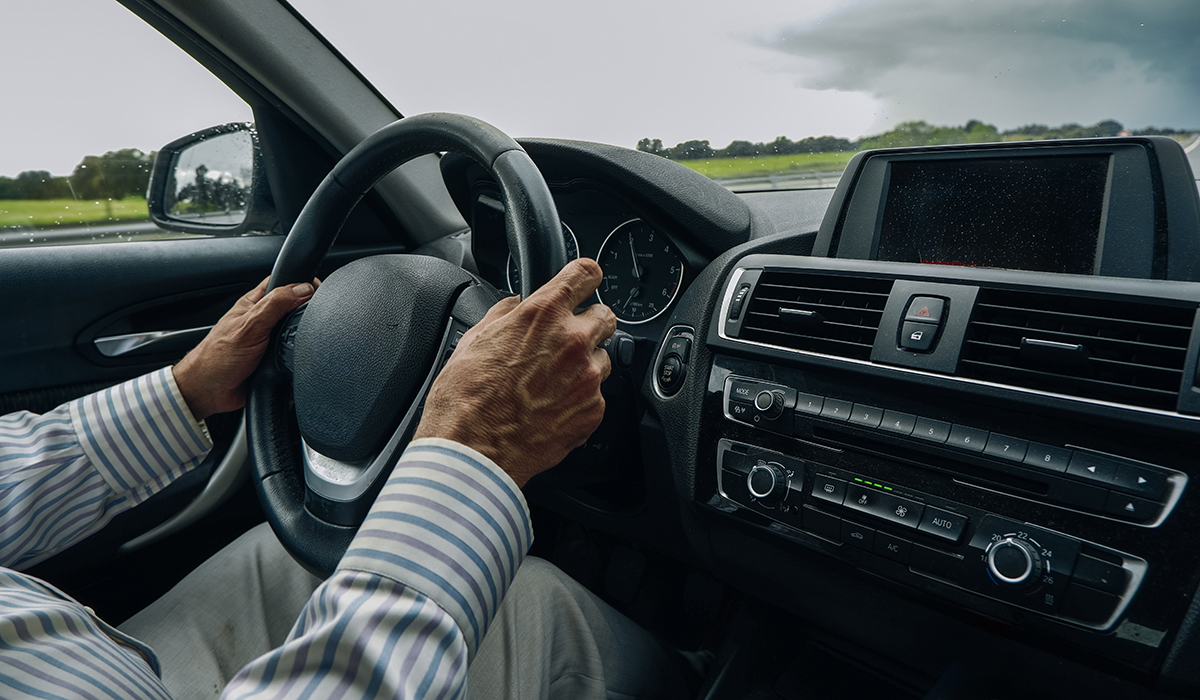 Businessman Driving Modern Car On Rainy Day