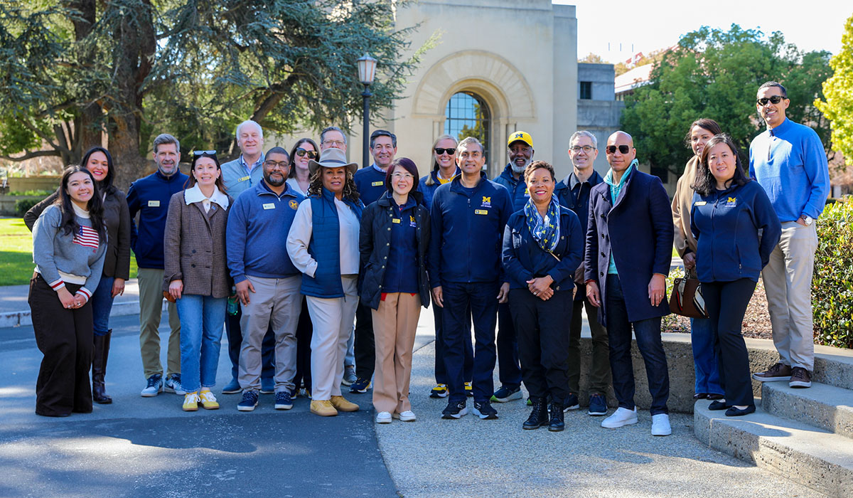 Members of the Alumni Association board of directors and others pose for a group photo outside at Stanford University.