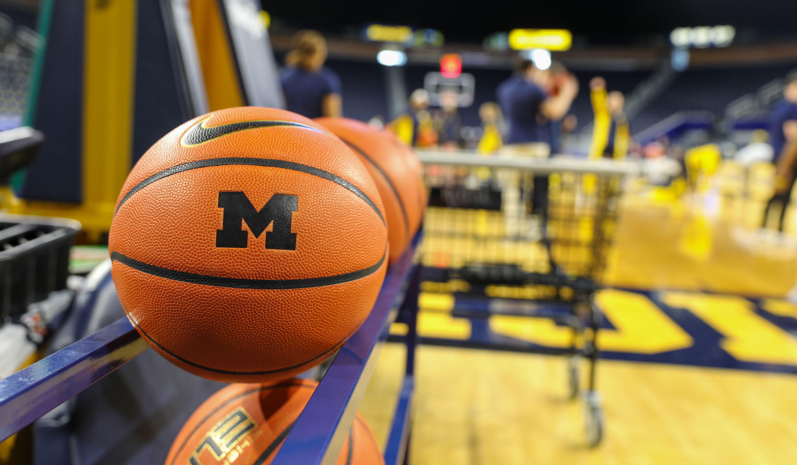 A Michigan basketball featuring a Block M sits on a rack at Crisler Center.