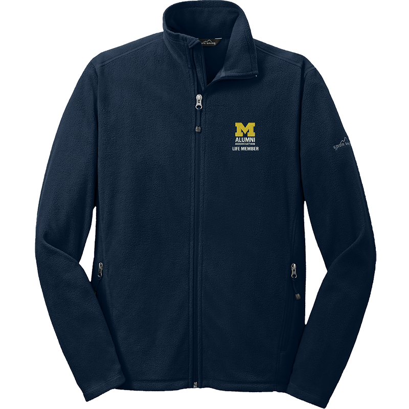 A navy Alumni Association of the University of Michigan fleece jacket. On the front-left chest, it features the Alumni Association logo, which includes a maize Block M and white text, and “Life Member” directly beneath it, also in white.