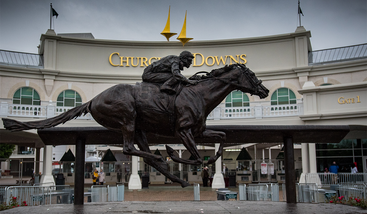 A statue of a jockey and a horse outside of Churchill Downs in Louisville, Kentucky.