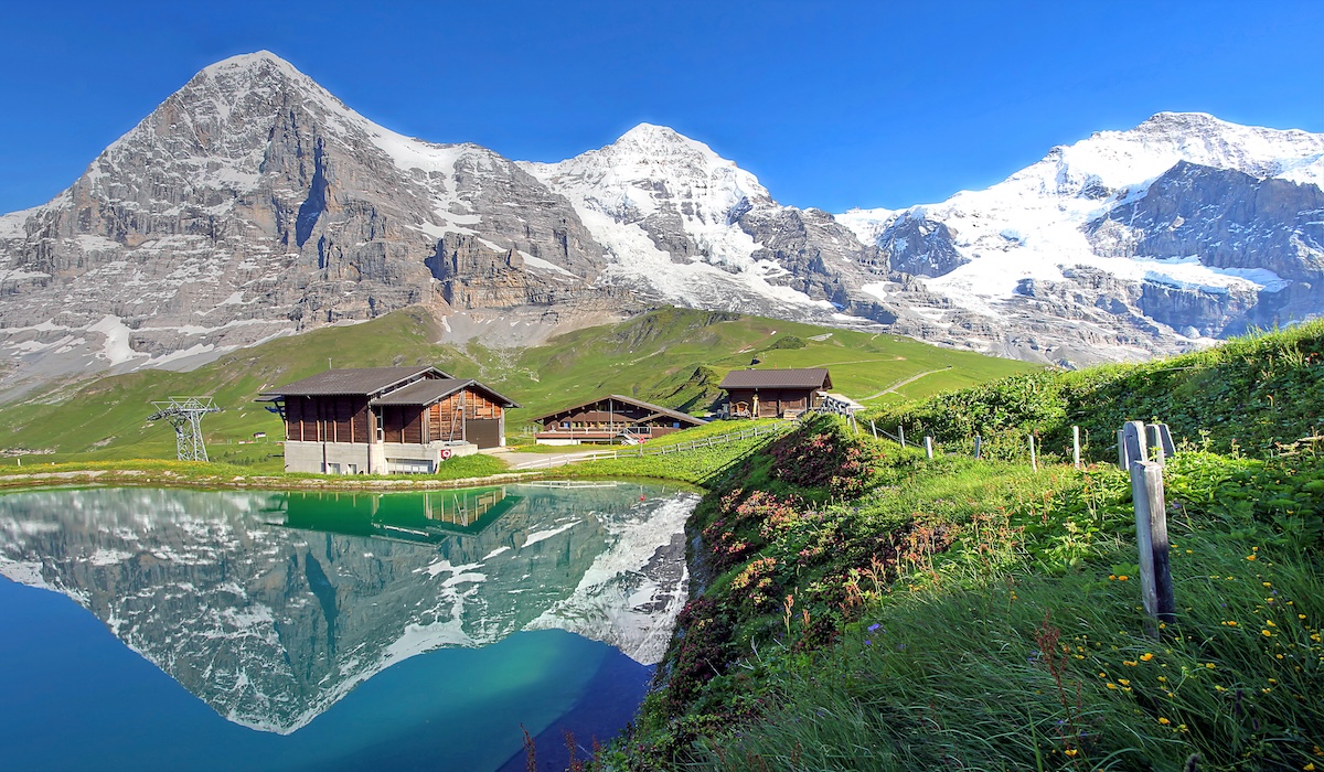 Eiger, Monch and Jungfrau in the Bernese Alps reflecting in a reservoir at Kleine Scheidegg, Switzerland