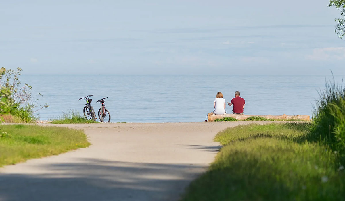 Older Couple Sitting By Water IHPI