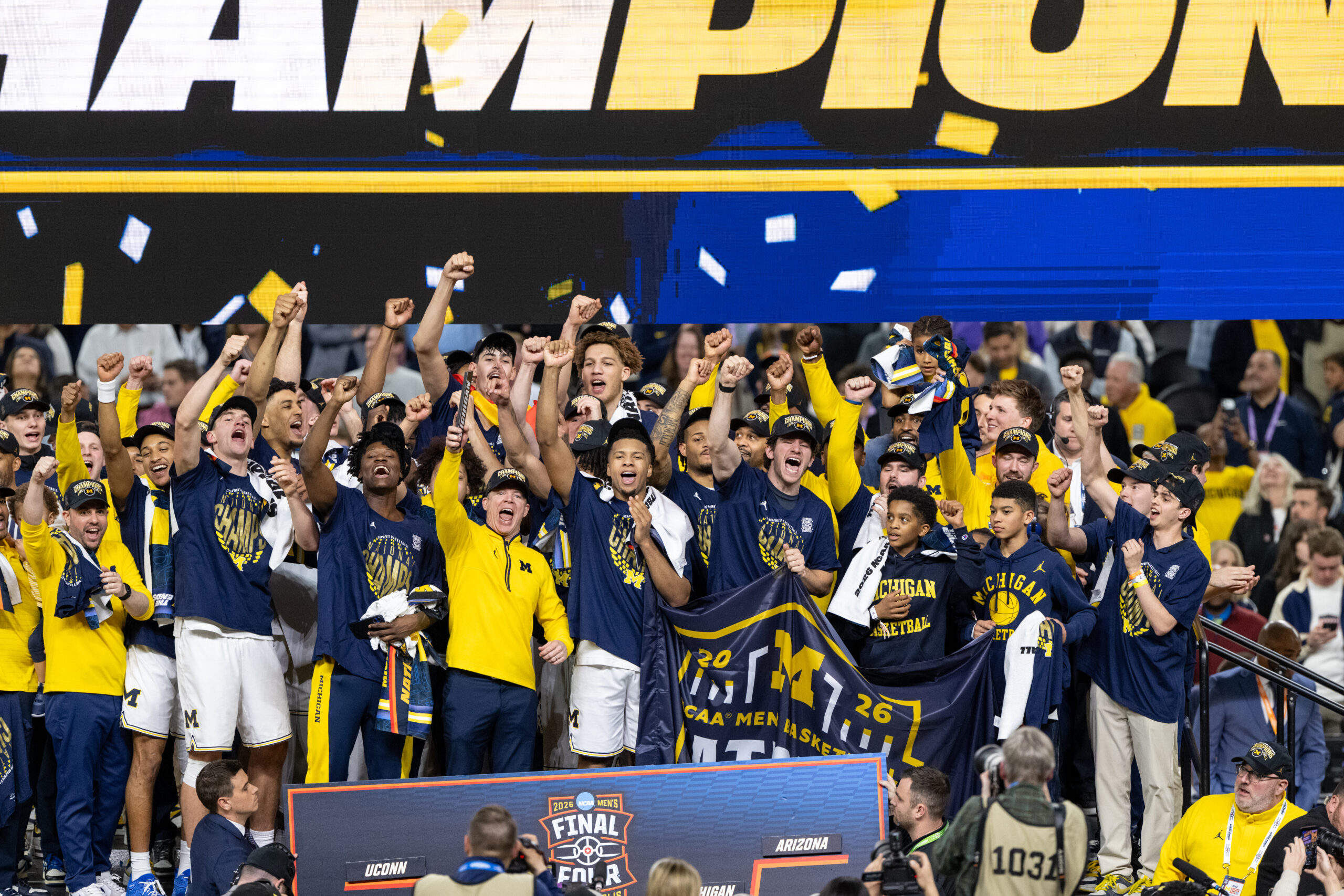 The men's basketball team, any many additional people, celebrate the national championship win.