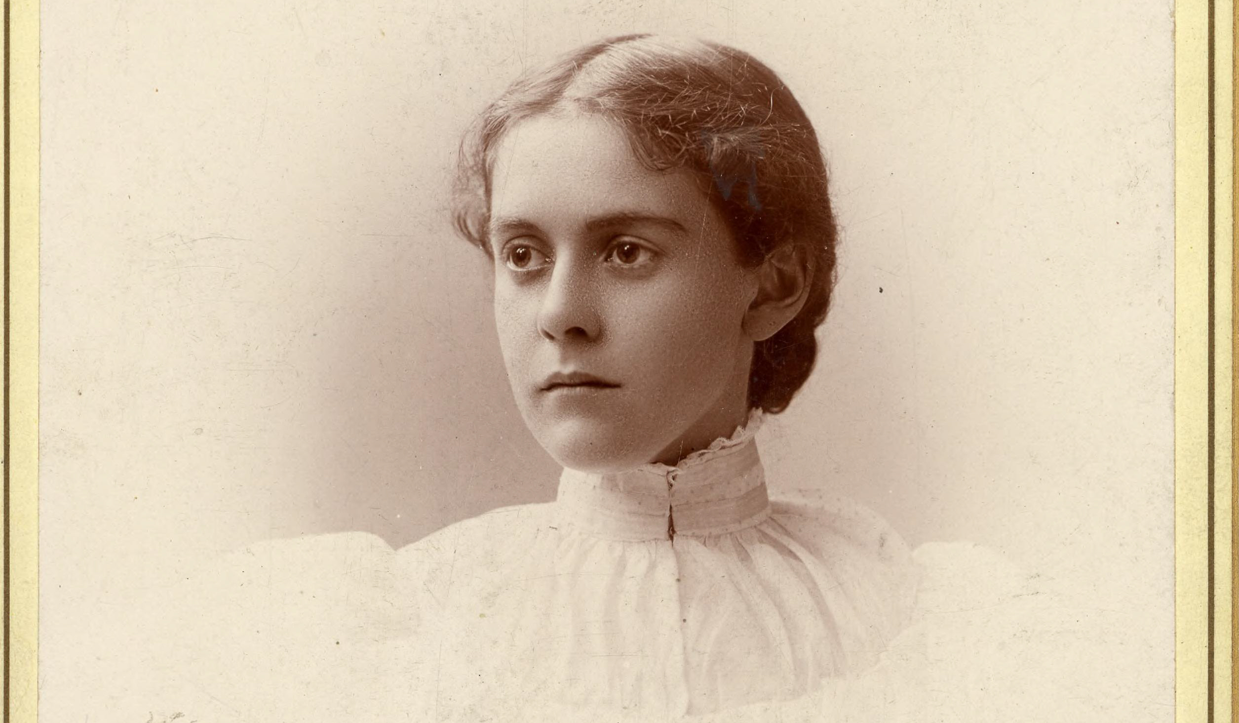A sepia-toned portrait shows a young woman with light skin, parted hair pulled back, and a ruffled blouse, looking right, neutral.