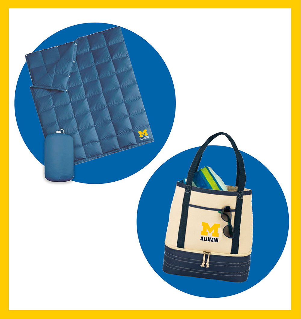 A blue blanket and cream-and-blue tote bag rest on blue circles and a white background inside a rectangular maize outline. Both items feature an M ALUMNI logo.