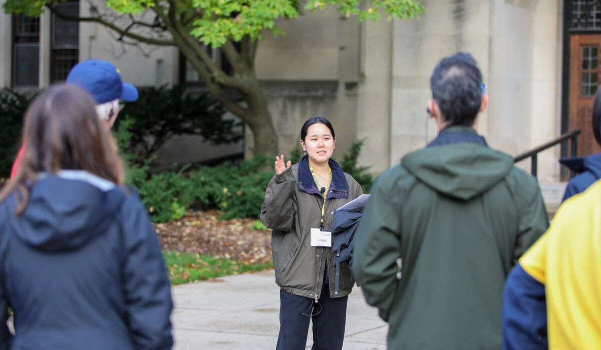 A woman talks as others look on and listen
