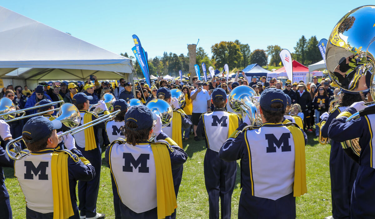 The Michigan fanfare band plays for a large crowd