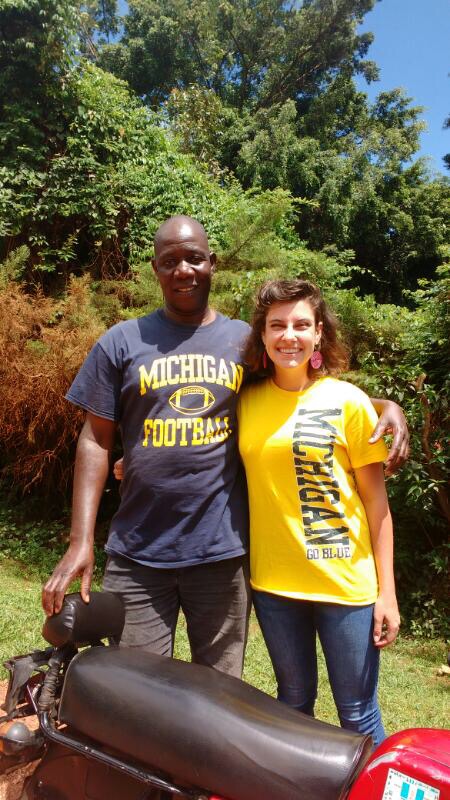 Abigail Meert, ’13, spent the 2016-2017 academic year in Uganda, traveling the country extensively to complete research on her doctorate dissertation in African history from Emory University. In this picture, Abby gets her boda boda driver, Geoffrey Kayiwa, in the Michigan spirit while in Kampala, Uganda. Boda boda are motorcycle taxis commonly found in East Africa.