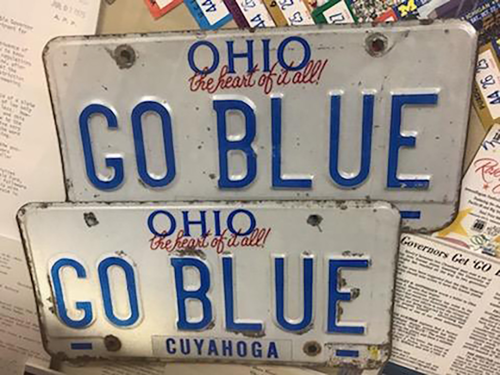When Albert Pickus, ’53, a former president of the Alumni Association, moved to Ohio he bravely got a GO BLUE license plate—and then another when the first one expired. An Ohio State fan and friend of Pickus, Stanley Gottsegen, decided to ramp up their rivalry in 1975. He wrote to Ohio Gov. James Rhodes, alerting him to a person “advertising and extolling the virtues of one of our most noteworthy competitors” and demanding the governor have the plate destroyed. Learning of the feud, Michigan Gov. William Milliken piped in soon after. He wrote a letter to Pincus commending his “extreme courage” and “true allegiance,” while promising to “marshal all the resources at my command” if the plate should be revoked by Ohio. Fortunately, the director of Ohio’s Department of Highway Safety could not legally revoke it because it was not obscene. But in his letter to Gottsegen delivering the bad news, the director added the final dig: “’GO BLUE’ followers need all the help possible in order to compete on an even basis with the Buckeyes.”