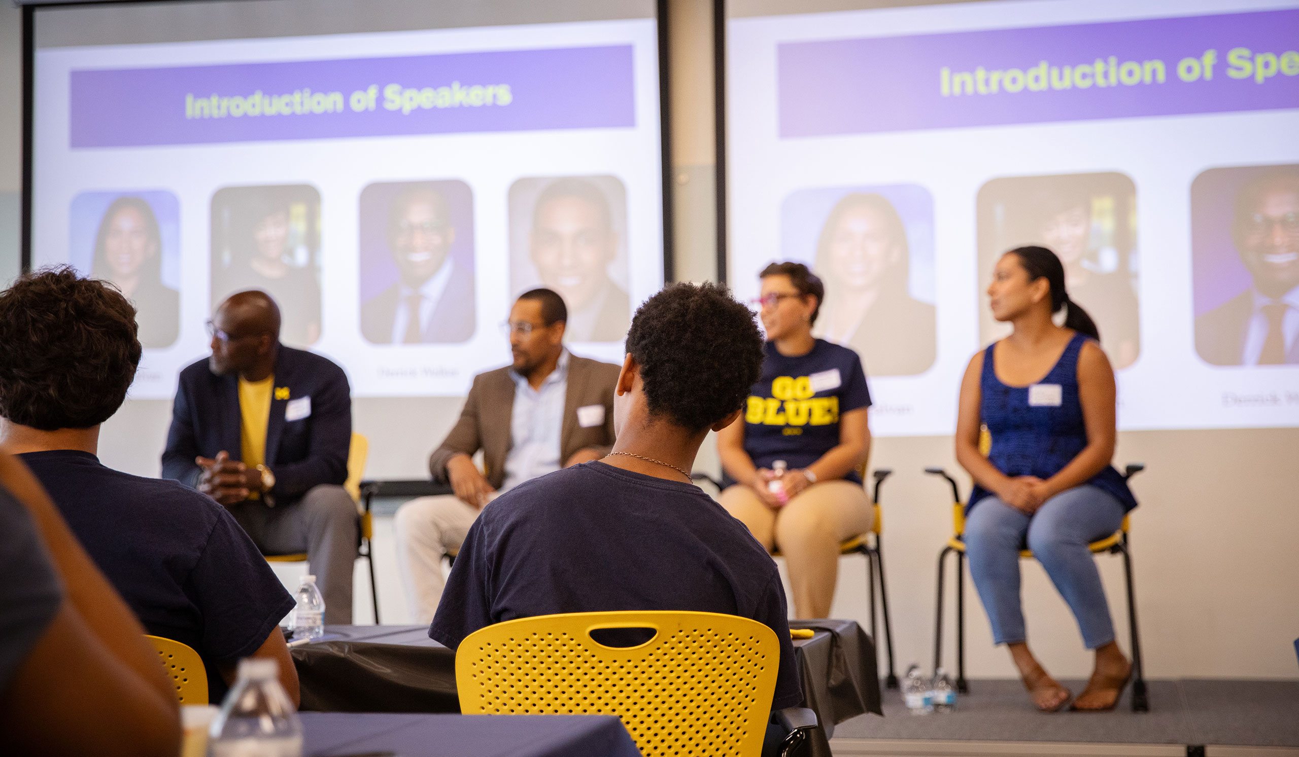 Students look on toward a panel of four University of Michigan alumni speakers.