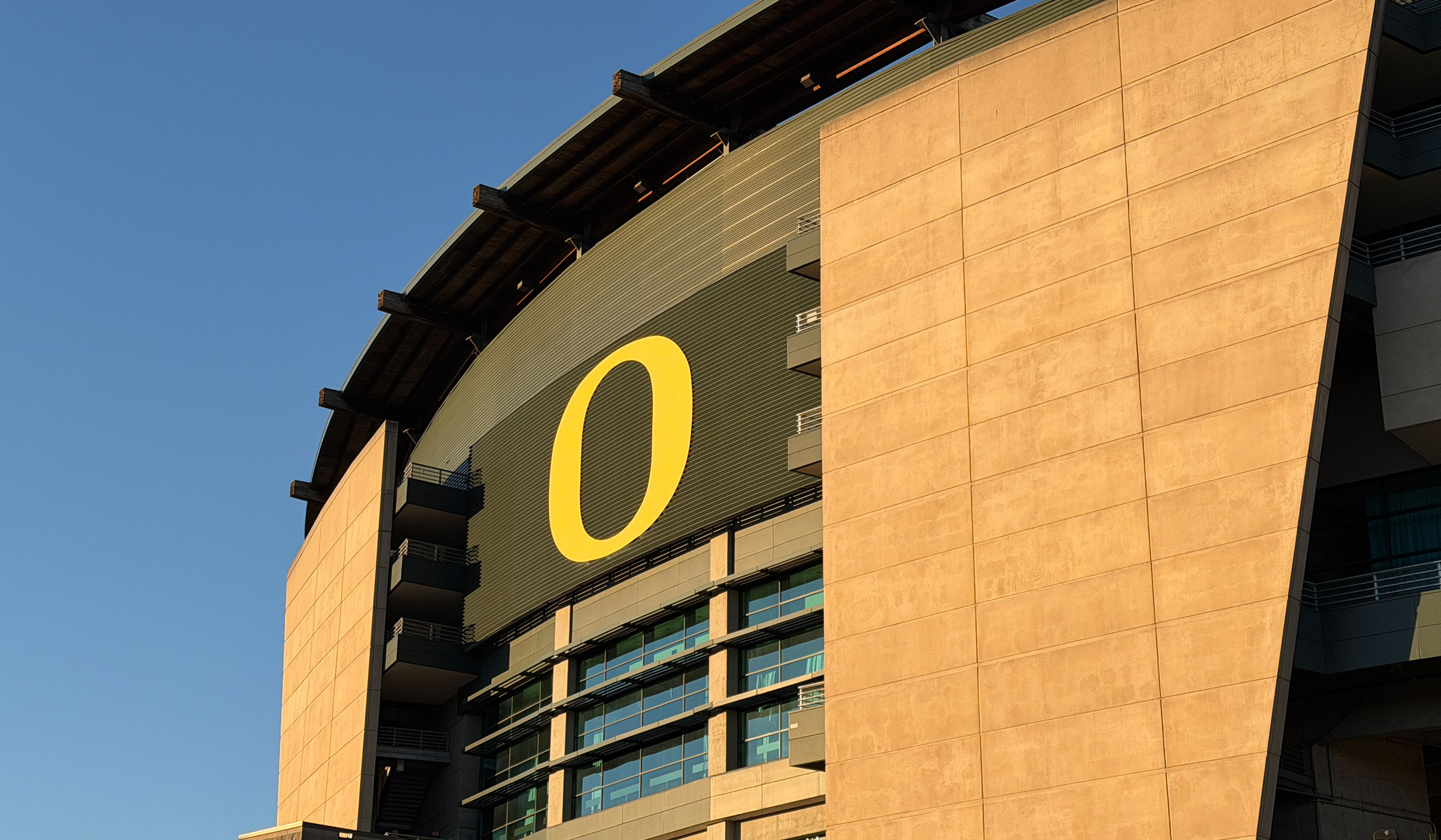A close-up of the exterior of Autzen Stadium, which features a yellow "O" on a green background.