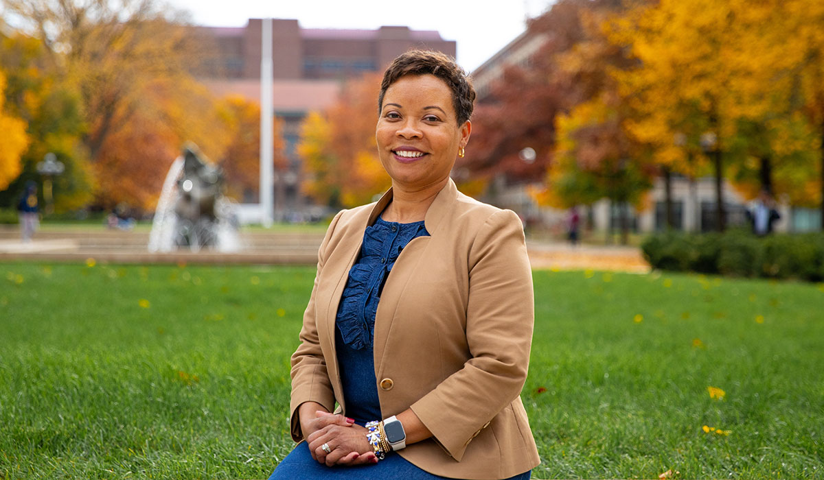 Ayanna McConnell, president and CEO of the Alumni Association of the University of Michigan, sits in Ingalls Mall on a fall day.