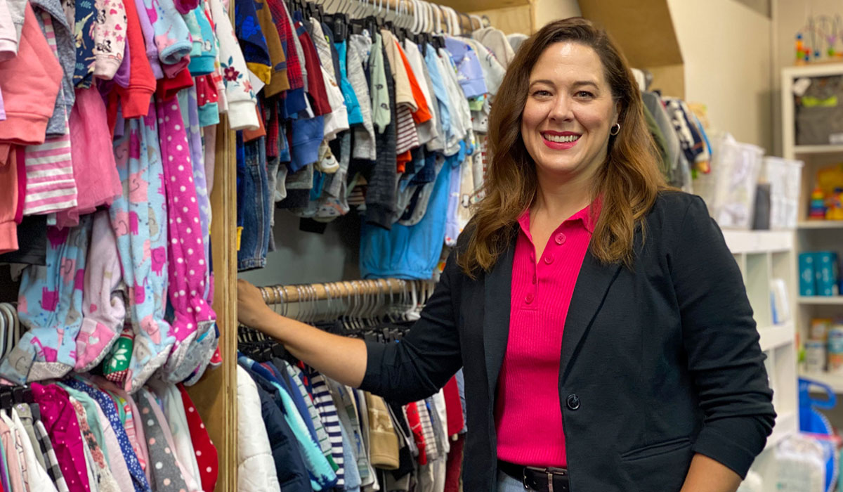 Heather Wing, MSW'04, in the infant clothing section at the Michigan Foster Care Closet.