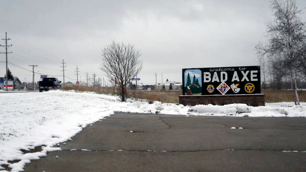 Snowy town sign that reads "Bad Axe."