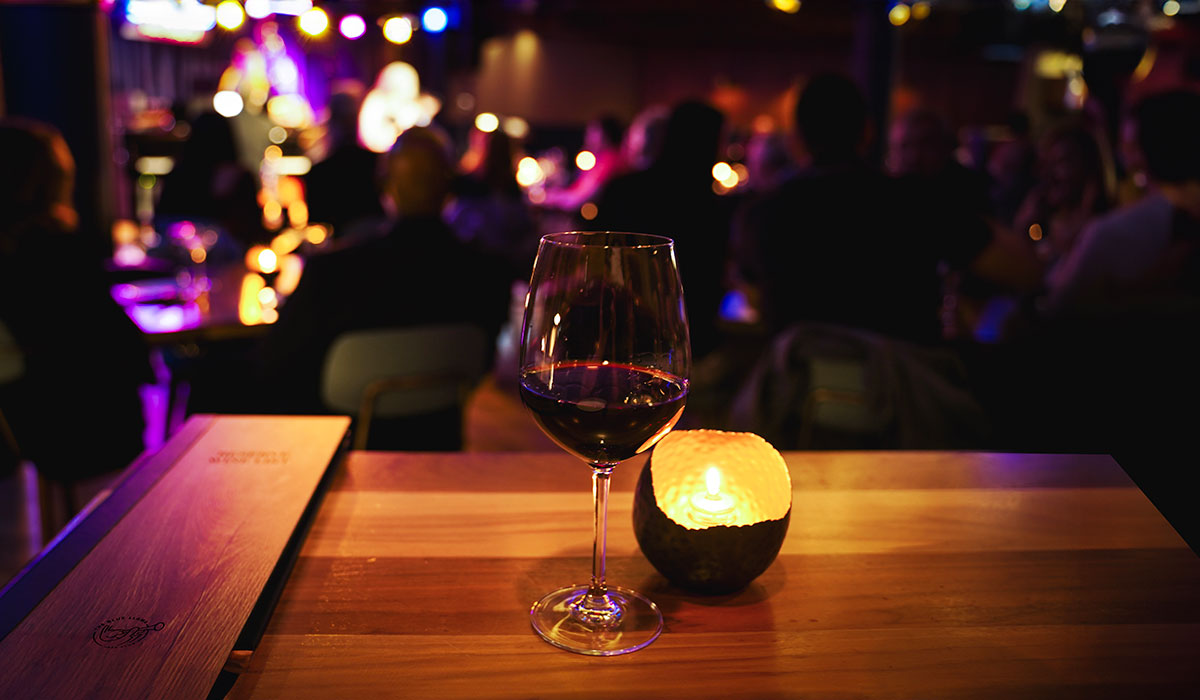 A wine glass next to a candle at the Blue LLama Jazz Club