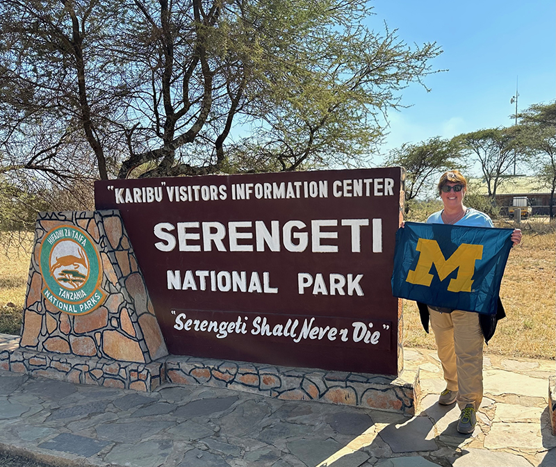 Perennial globetrotter Julie Bockoff, ’87, took her Maize and Blue flag to Tanzania’s Serengeti National Park in July 2023. The flag has been everywhere with her as she’s journeyed across all seven continents.