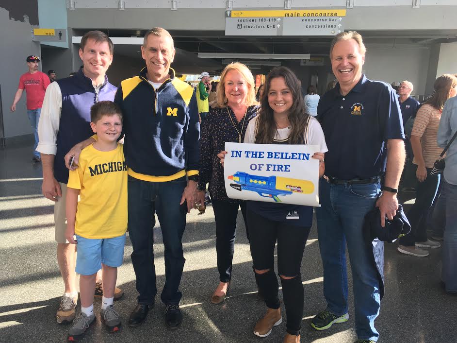 Lauren Caisman, ’10, poses with members of Wolverine men’s basketball coach John Beilein's family prior to the Sweet 16 in Kansas City, Mo.