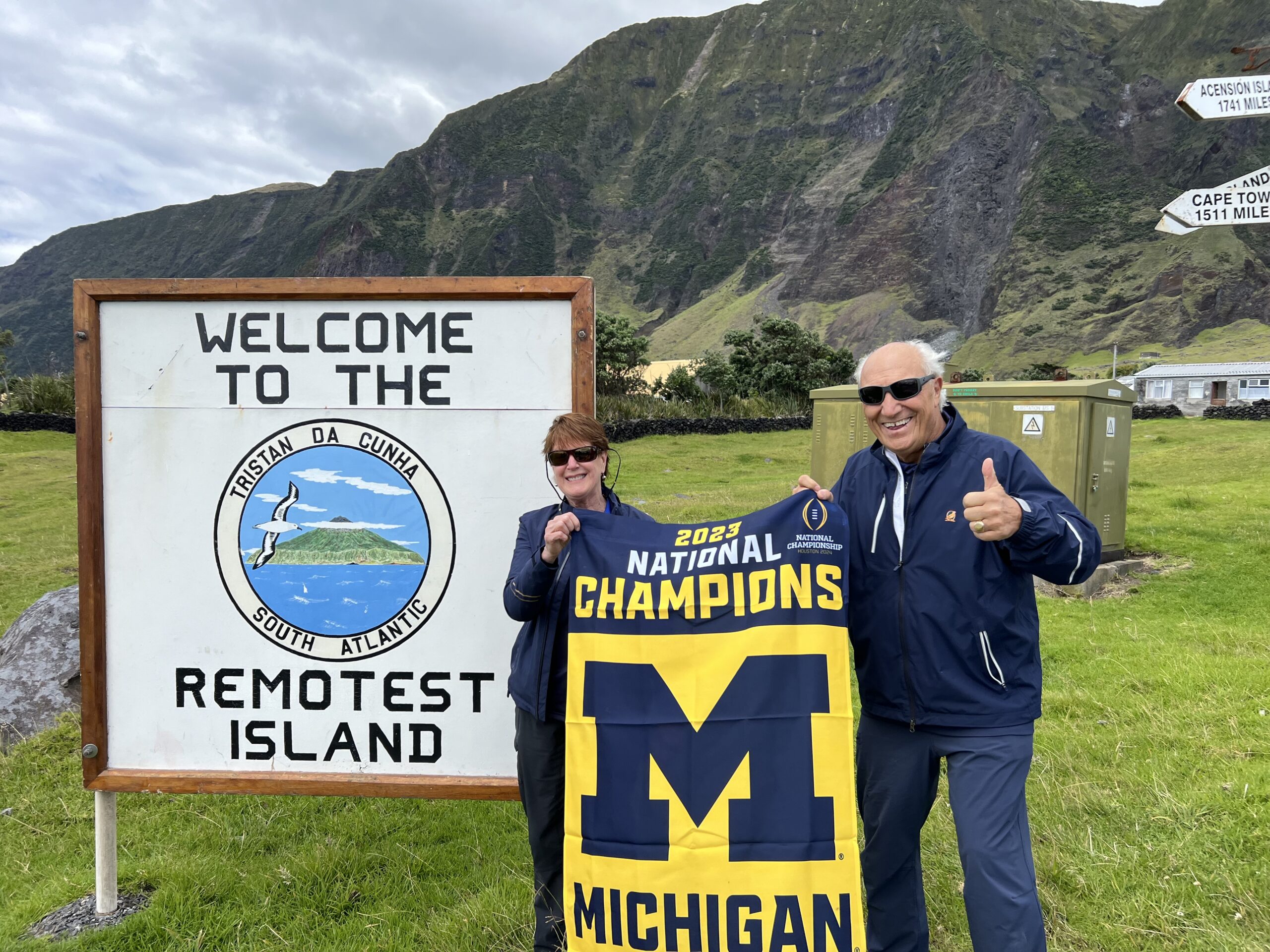 Eileen Weiser, MMUS’75, and Dick Caldarazzo, ’70, celebrate U-M’s football success from the “Remotest Island” of Tristan da Cunha in the middle of the Atlantic Ocean.