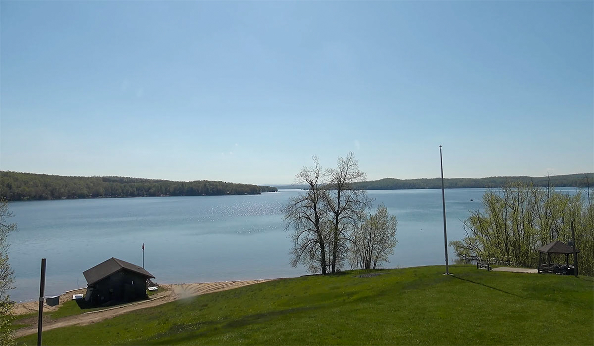 A sunny view of Walloon Lake under a perfect blue sky at Camp Michigania.