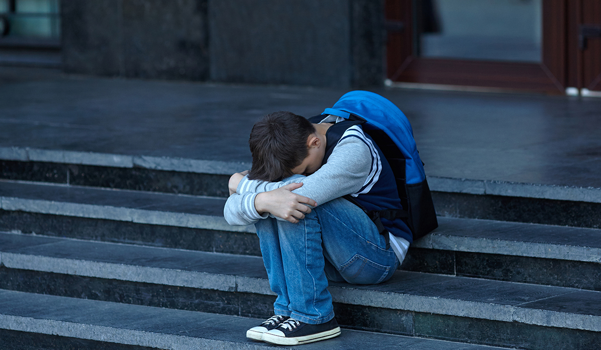 Schoolboy Crying In The Yard Of The School