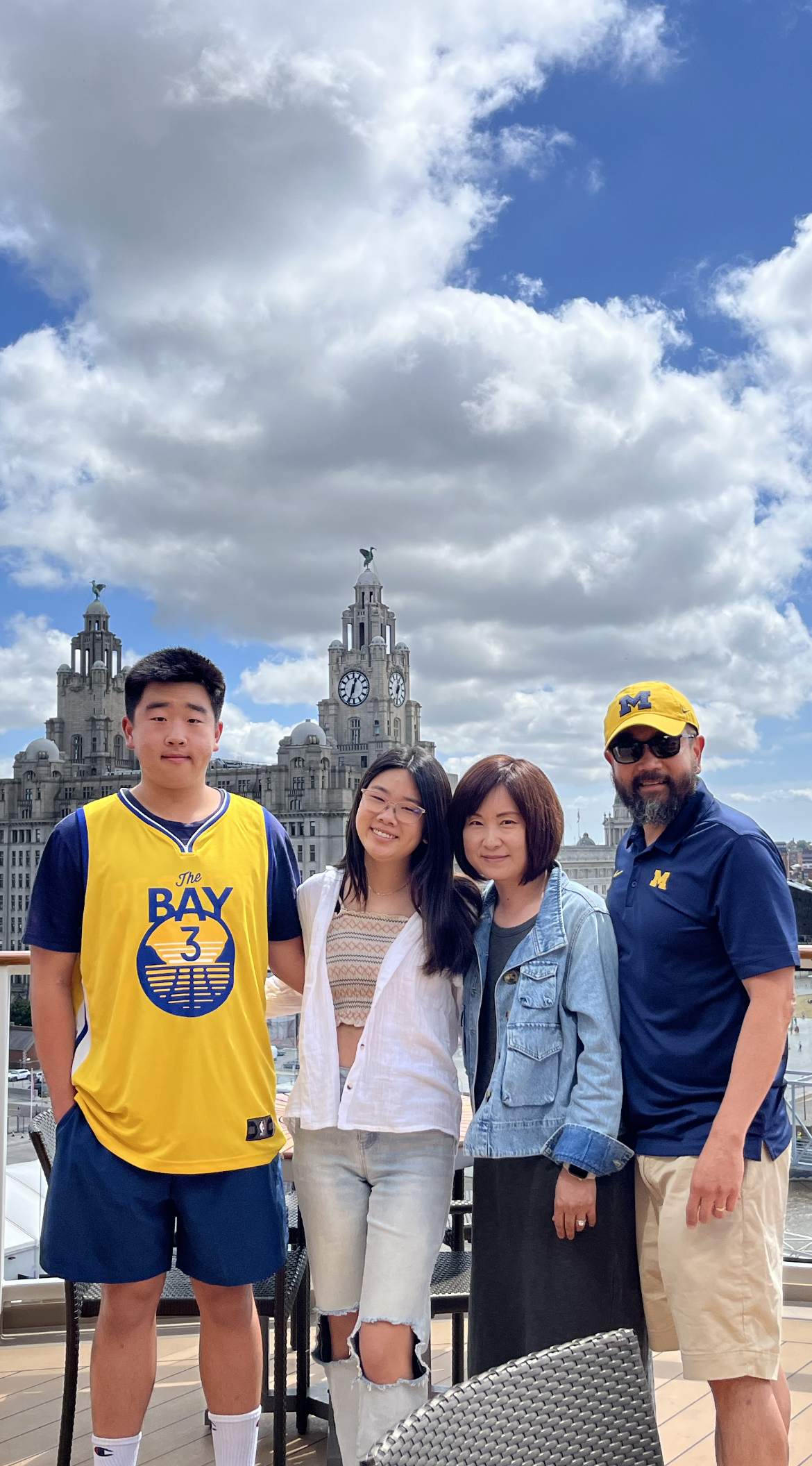 Over the summer, John Cho, ’89 (right), and his family took the Wolverine spirit to Liverpool, England.