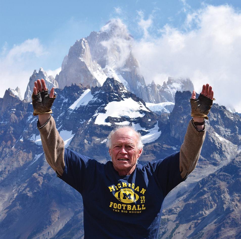 Dave Courtis, ’63, MS’65, signals his support for U-M football in front of Mount Fitz Roy (11,171 feet) in Patagonia, Argentina.