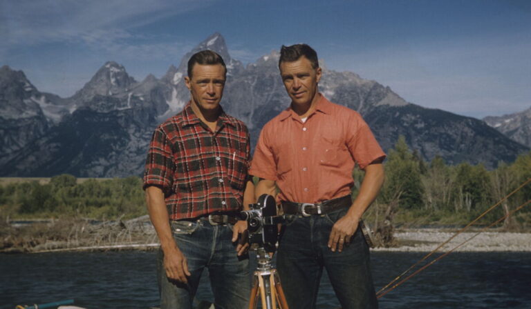 Frank and John Craighead standing against a picturesque mountainous background