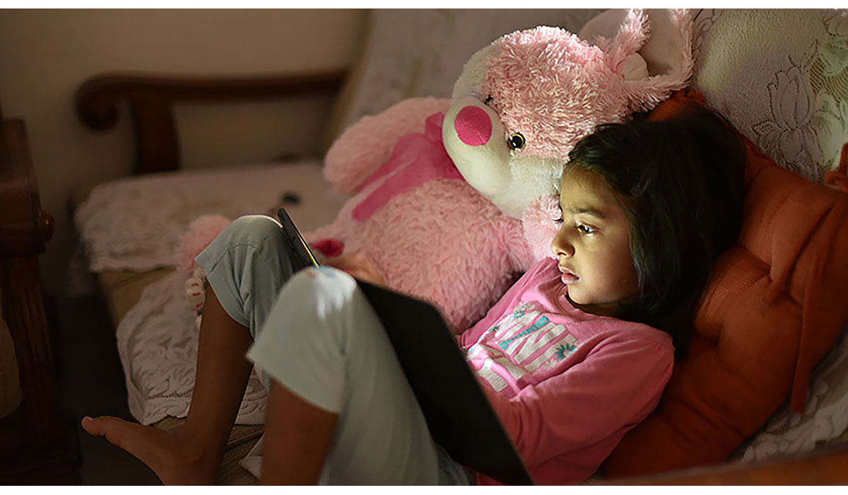 Young Girl Using Digital Tablet Along With Her Soft Toy