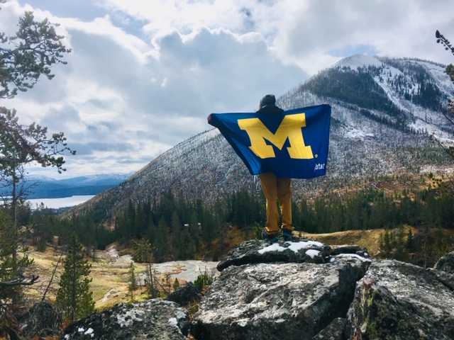 Sarah Halperin, ’15, daughter of Larry Halperin, ’82, posed with the Maize and Blue at Yellowstone National Park.