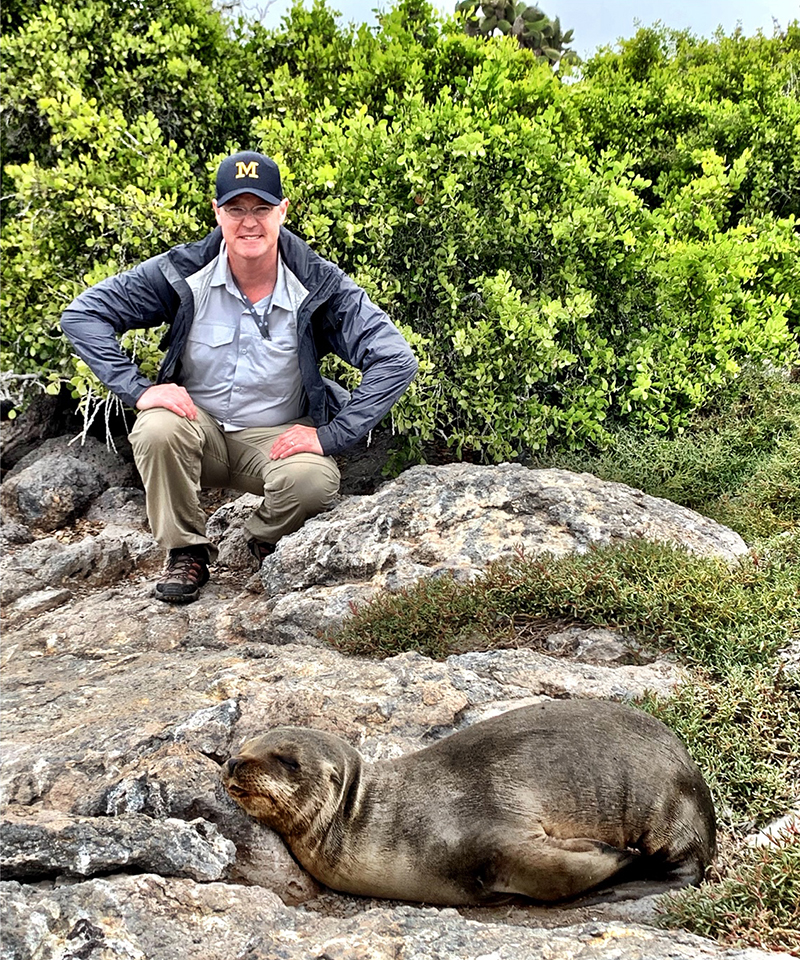 Jeff Hartgen, ’91, chilled out with a sea lion on the Galápagos Islands.