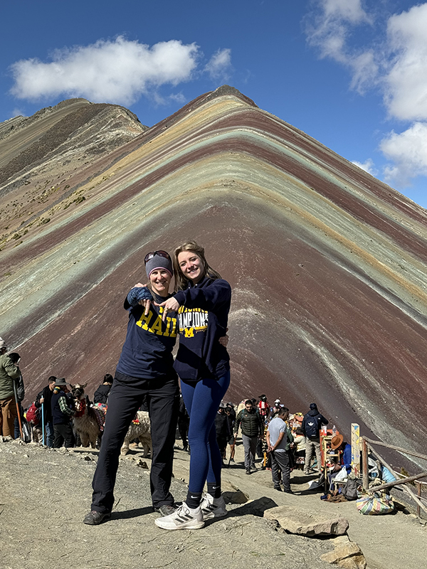 Louise Hofer, ’92, and current U-M student Megan Galantowicz graced the hillside of Rainbow Mountain in Peru (pictured) and the Great Salt Flats in Bolivia with their Wolverine pride.