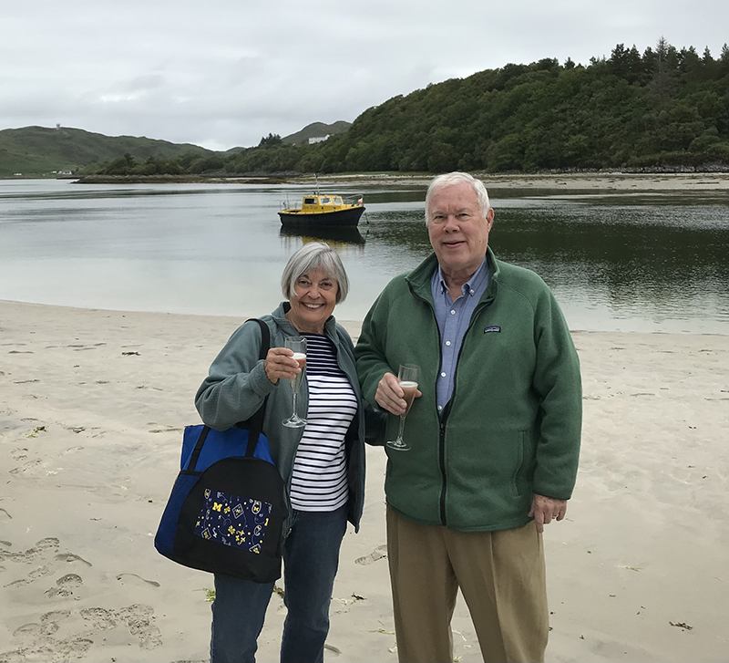 Donna and Lee Hornberger, ’66, JD’68, showed their true-blue colors while walking along the Silver Sands of Morar, enjoying views across the Sound of Sleat to the Isle of Skye in Scotland.