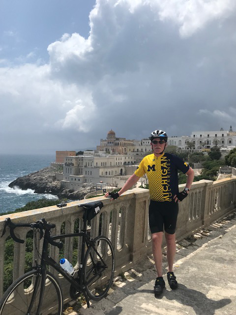 George “Peter” Hussey, ’74, was delighted to wave the flag for the Michigan Cycling Team during a recent trek through Santa Cesarea Terme, Italy.