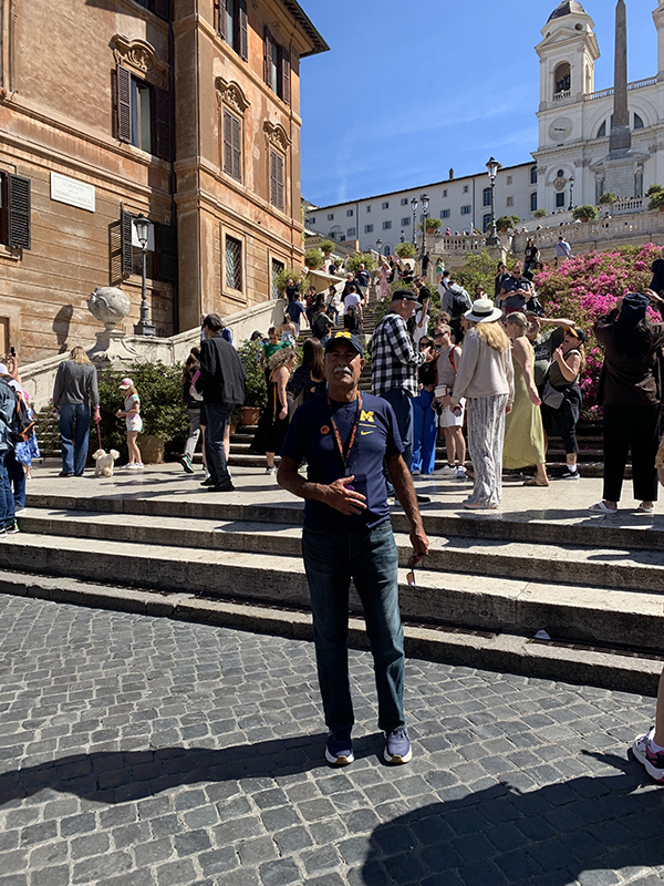 Richard Husty, ’76, spent Cinco de Mayo in Rome, Italy, at the Spanish Steps, showing off his Maize and Blue support.