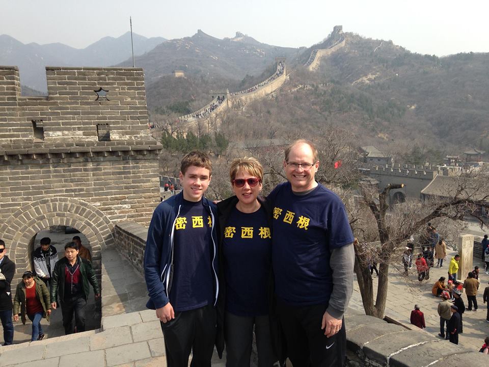 Scott M. Hyslop, AMusD’07, his wife, Dora, and their son (and future Wolverine), Nicholas, spent ten days in China. The family split their time between Shanghai and Beijing. The trio posed for a photo on the Great Wall of China while wearing their Mandarin-script Michigan shirts.