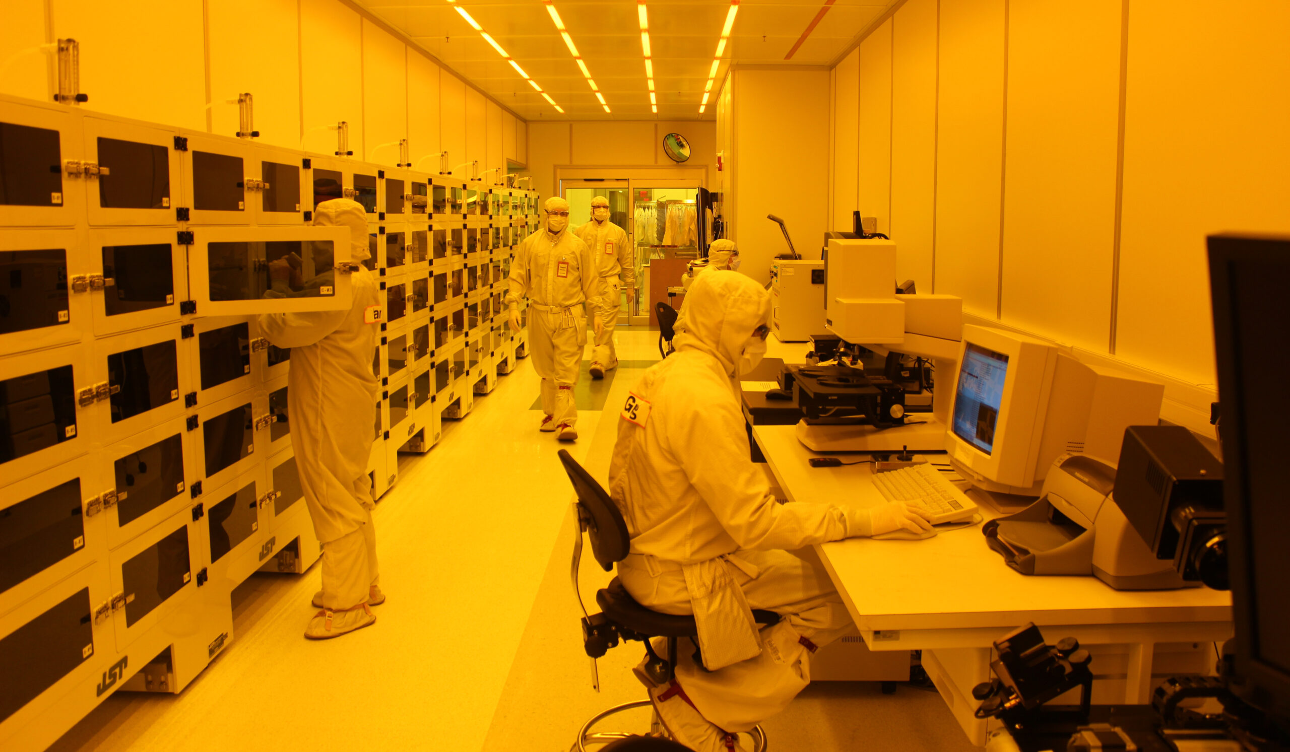 A yellow-toned photo inside the LNF, with people in clean suits.