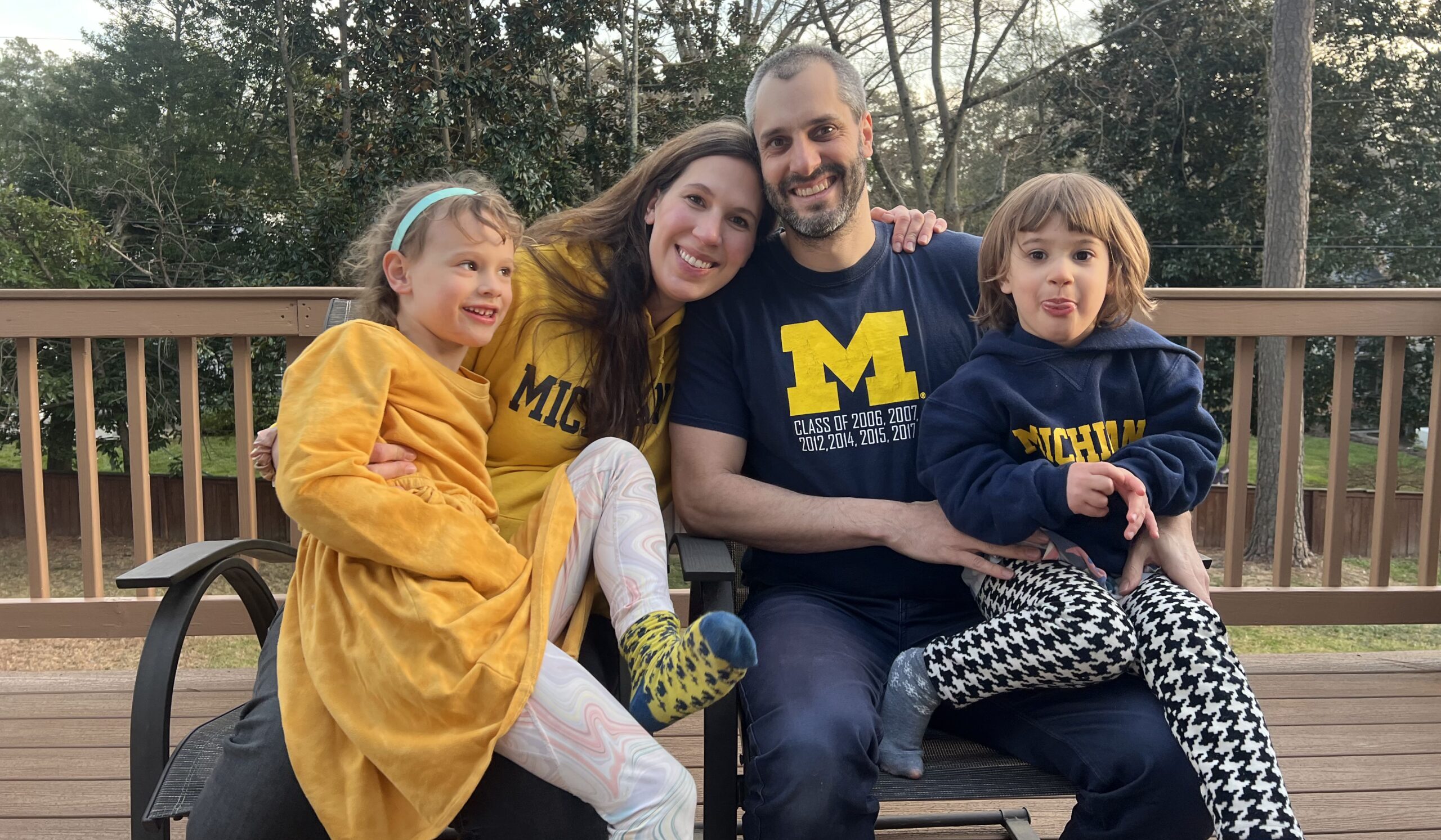 Daniel Schaffa (middle right) poses with his wife (middle left) and two of his daughters. They're all wearing maize and blue Michigan gear.