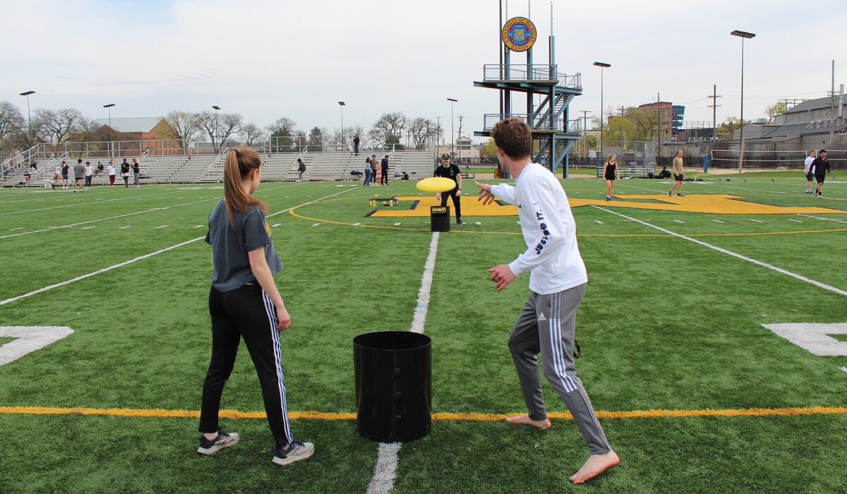 Students play with a Frisbee at Elbel Field