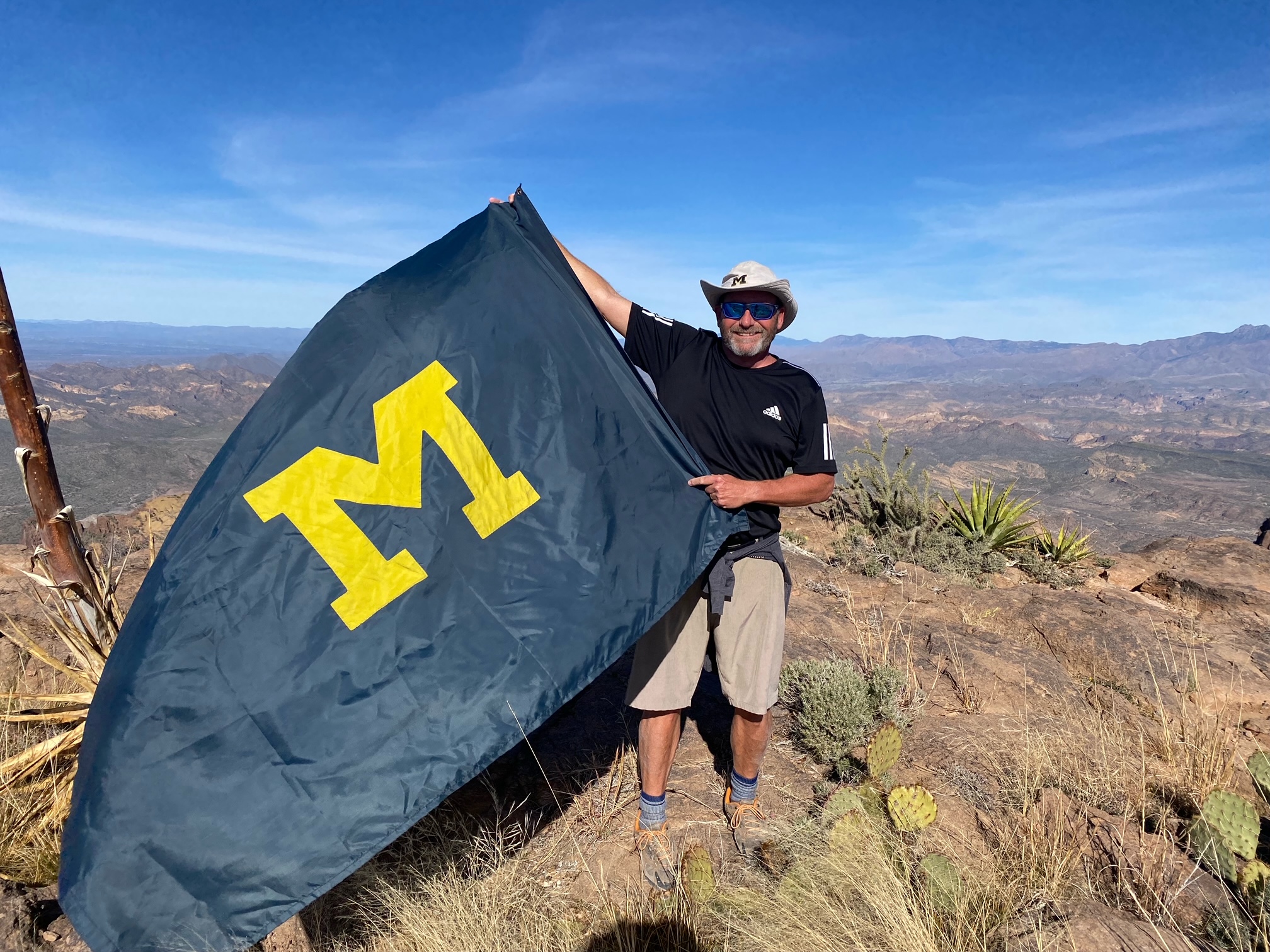 Andrew Kneisel, ’87, took the Maize and Blue with him as he hiked to the Flatiron in Apache Junction, Arizona, in December.