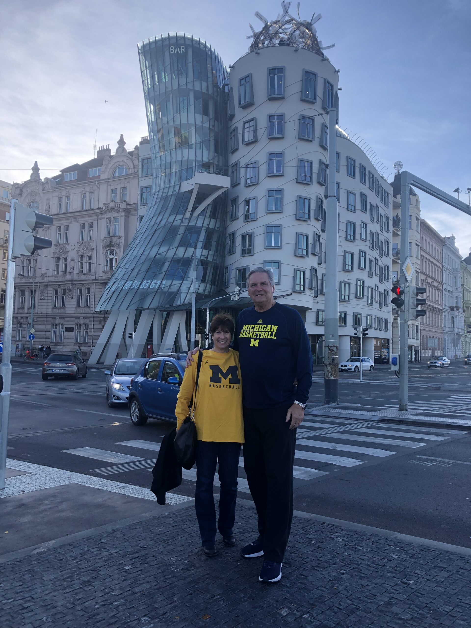 Vicki and C.J. Kupec, ’75, finally made a journey to Bohemia, Czech Republic, the region of his ancestors. The couple is pictured in front of the “Dancing House” in prague. C.J. was interviewed on television about his professional basketball career and being in the Czech-Slovak basketball museum.