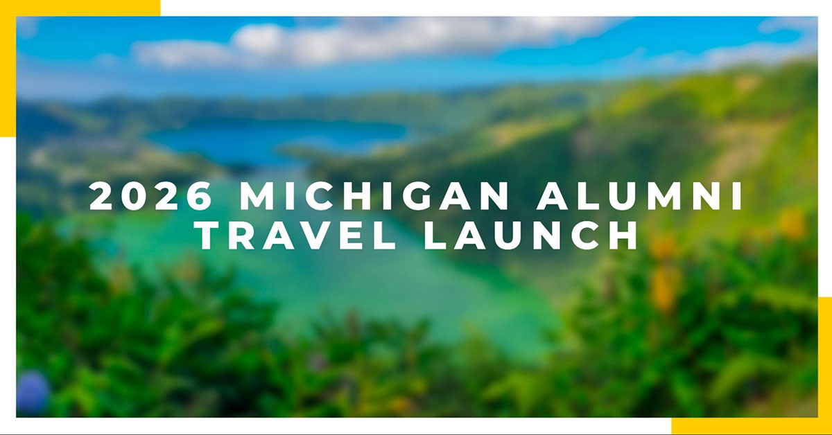Text that says "2026 Michigan Alumni Travel Launch" on a blurred landscape featuring green trees and blue water.