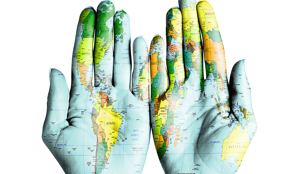 World Map On Palms Of Woman On Isolated White Background