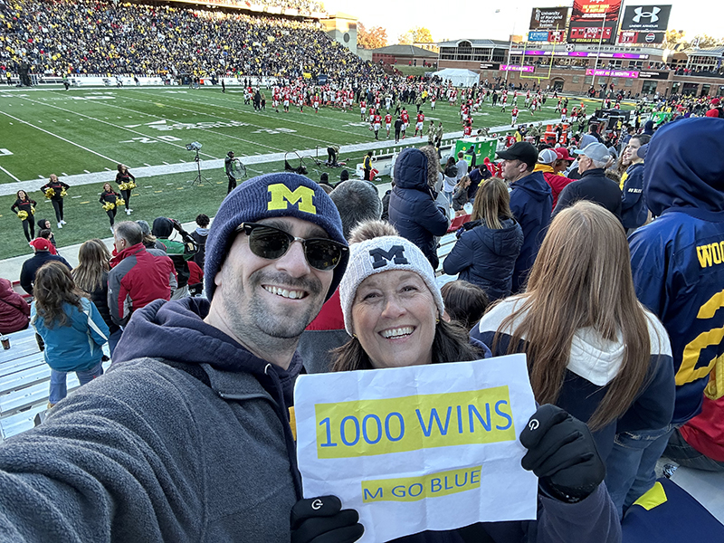 Alex Marston, ’10, and his mom, Eileen Horowitz Marston, ’78, celebrated the Wolverine’s 1000th football win in November.