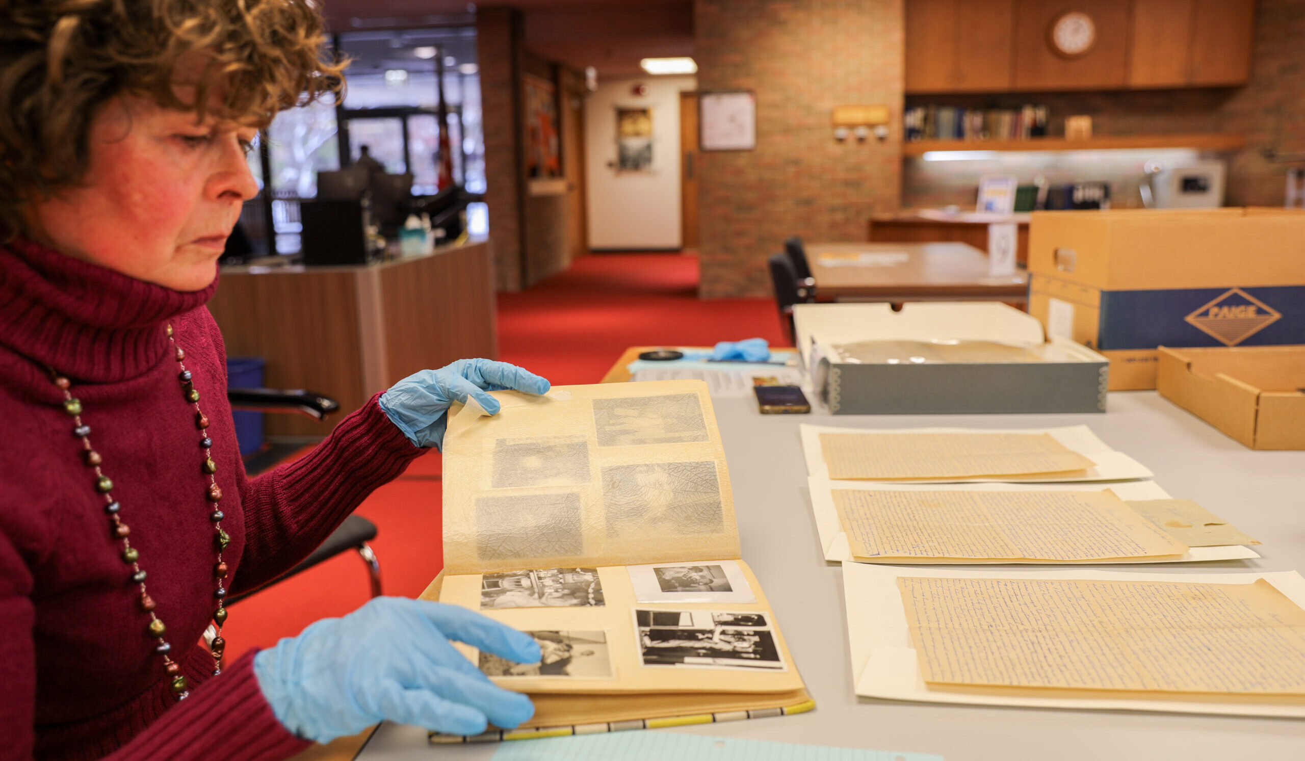 MaryAnn Sarosi looks over some of the letters and family photographs included in her family's vast collection at the Bentley Historical Library in Ann Arbor.
