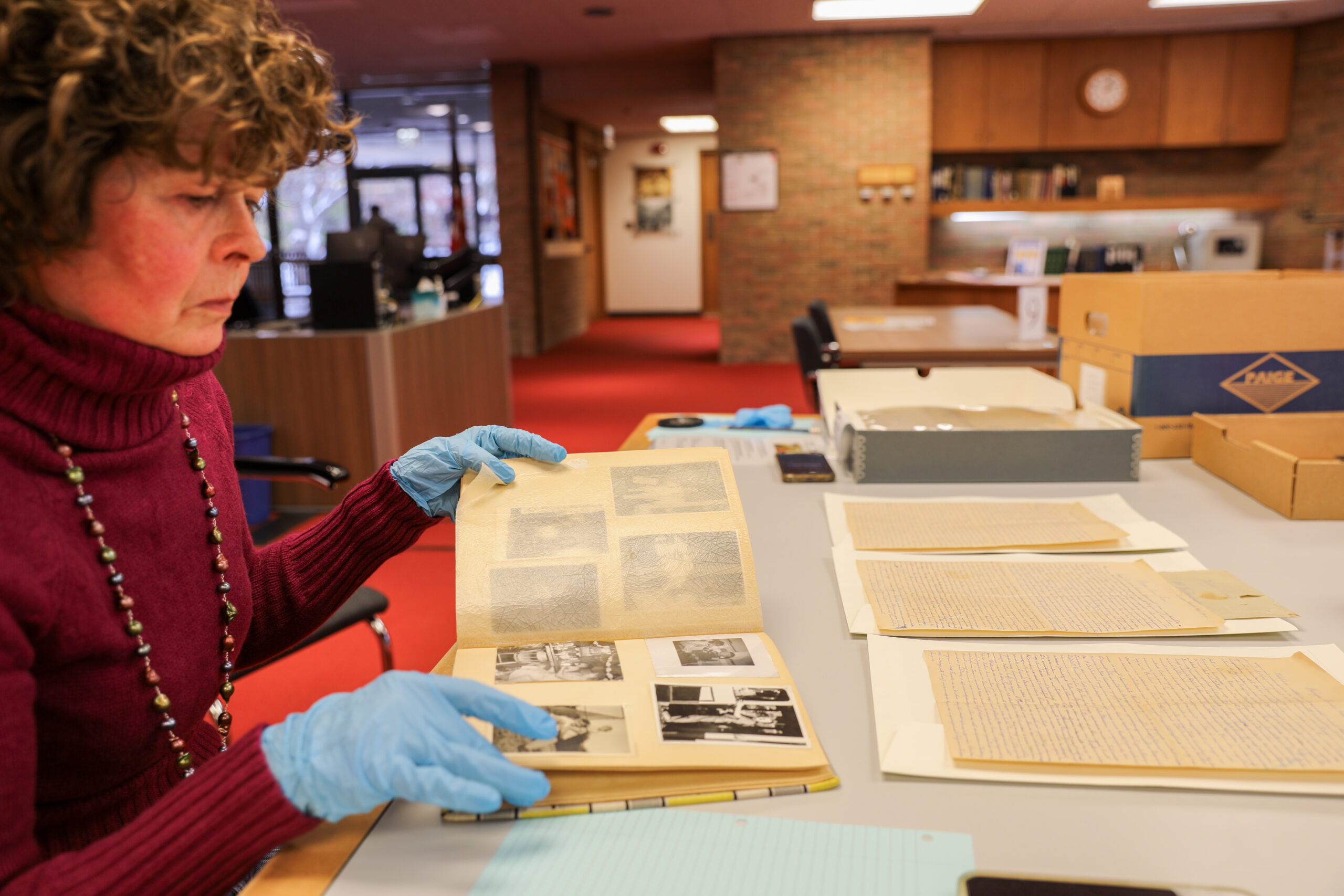 MaryAnn Sarosi looks over some of the letters and family photographs included in her family's vast collection at the Bentley Historical Library in Ann Arbor.