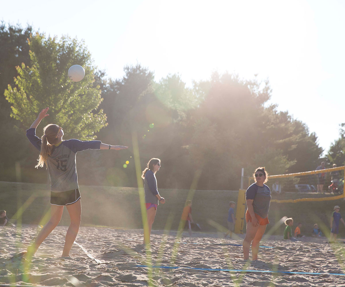 People playing volleyball at Camp Michigania