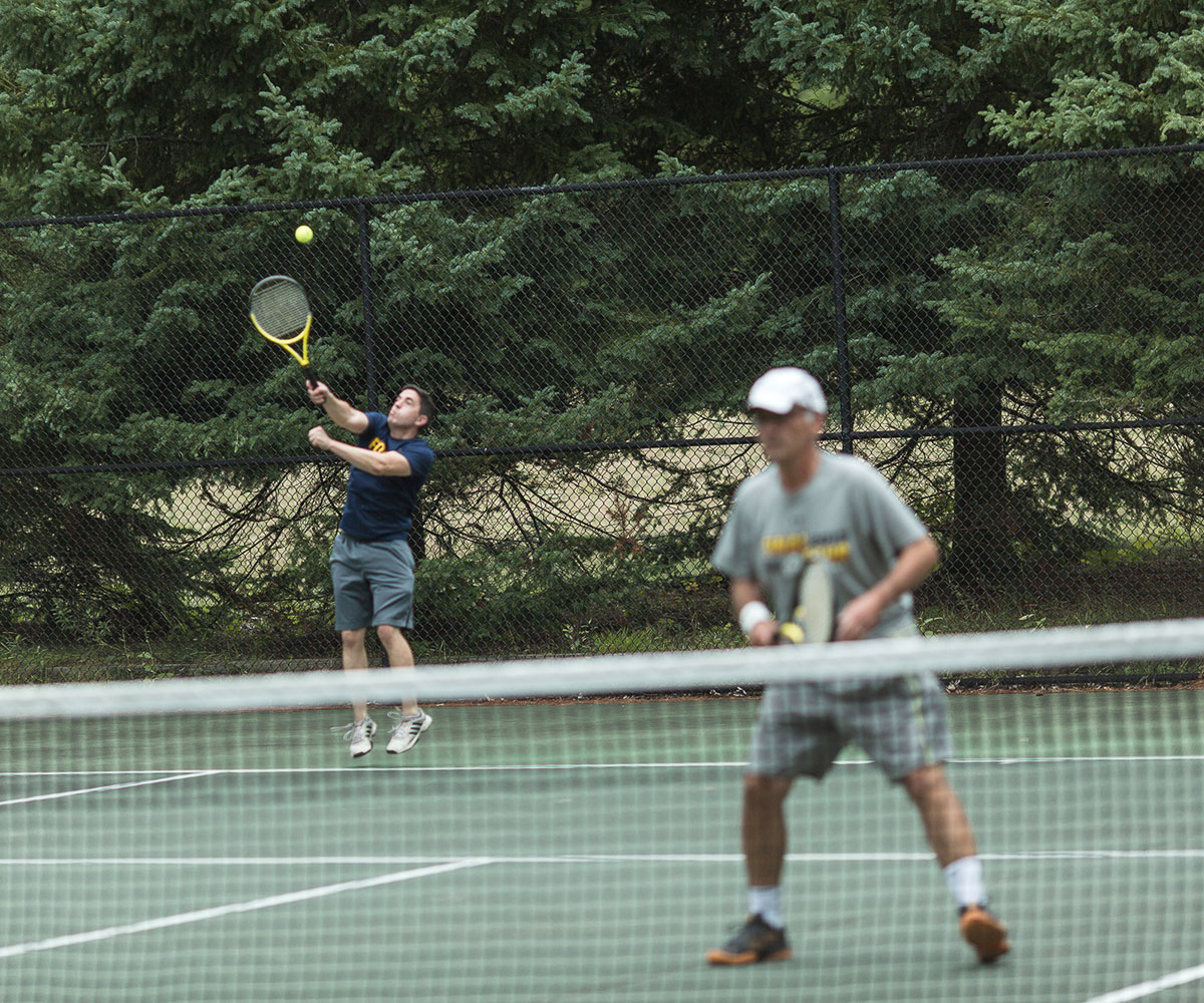 Two people playing tennis at Camp Michigania