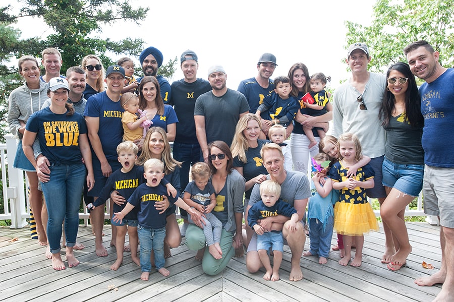 Betsy, ’05, and Jeff Nelson, ’04, get together each year with 13 other alumni (and a crop of future alumni!) every year to cheer on Michigan football.