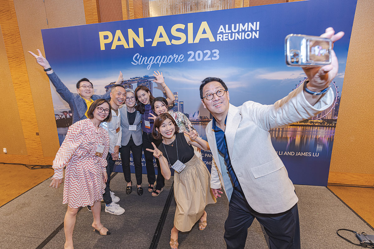 U-M President Santa Ono takes a selfie with a group of people at the 2023 Pan-Asia Alumni Reunion